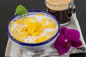 Cornflakes in a bowl on wooden background photo