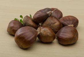 Chestnut on wooden background photo