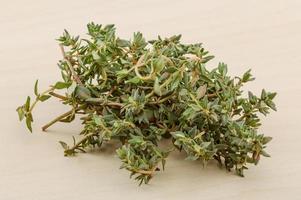 Thyme on wooden background photo