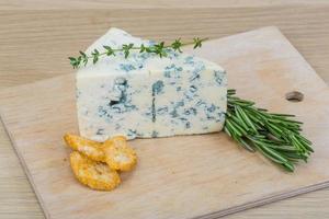 Blue cheese on wooden board and wooden background photo