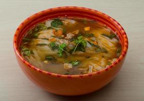 Soup Pho in a bowl on wooden background photo