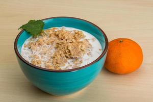 Cornflakes in a bowl on wooden background photo