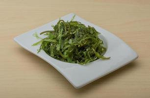 Chuka salad in a bowl on wooden background photo