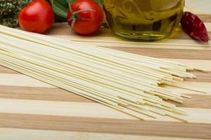 Egg spaghetti on wooden board and wooden background photo