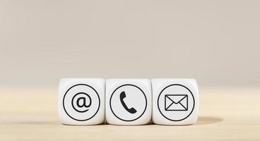Contact us icons on white cube blocks photo