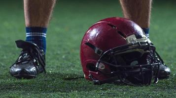 closeup of american football player and helmet photo