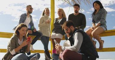 Group of friends having fun on autumn day at beach photo