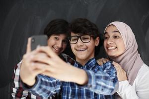 group of arab teens taking selfie photo on smart phone