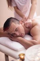 young man having a back massage photo