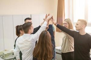 students celebrating successfully finished project photo