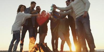 Friends on beach party drinking beer and having fun photo