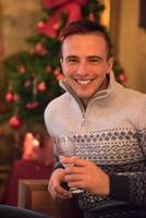 Happy young man with a glass of champagne photo