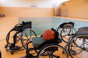 a photo of the wheelchair, wheelchair equipment and ball located in the arena before the game