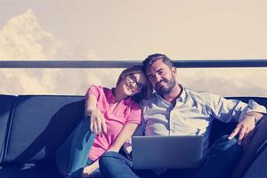 couple relaxing at  home using laptop computers photo