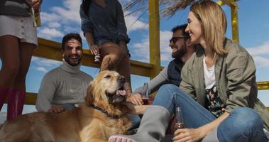 Group of friends having fun on autumn day at beach photo