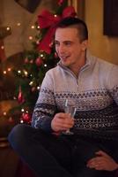 Happy young man with a glass of champagne photo