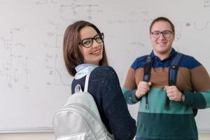 portrait of young students in front of chalkboard photo