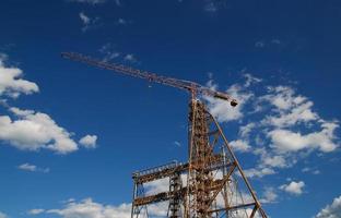 crane with dramatic clouds  in background photo