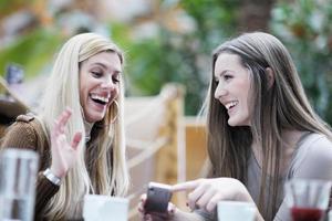 cute smiling women drinking a coffee photo