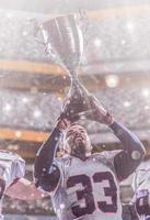 american football player with trophy celebrating victory in the cup final photo