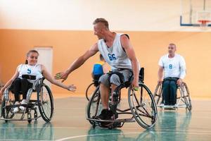 a team of war veterans in wheelchairs playing basketball, celebrating points won in a game. High five concept photo