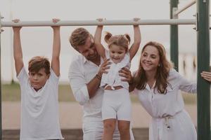 Senior couple in casual clothes with their children spending time in park a vacation together. Family time . Selective focus photo