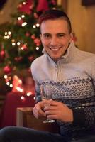 Happy young man with a glass of champagne photo