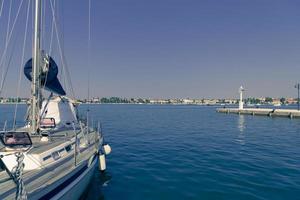 A photograph of a ship and a luxury yacht anchored in port. Beautiful photo of a Mediterranean port