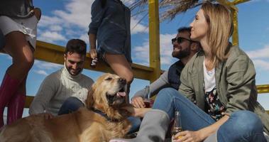 Group of friends having fun on autumn day at beach photo