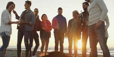 Friends having fun at beach on autumn day photo