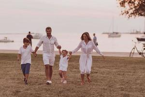 Senior couple in casual clothes with their children, boy and girl enjoy the beach spending a vacation together. Family time . Selective focus photo