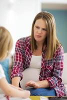 daughter painting nails to her pregnant mom photo