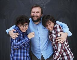 happy father hugging sons photo