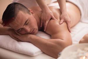 young man having a back massage photo