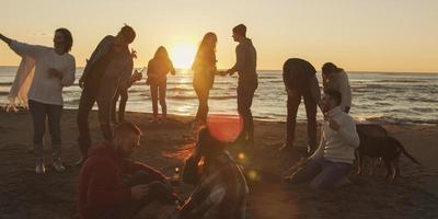 Friends having fun at beach on autumn day photo