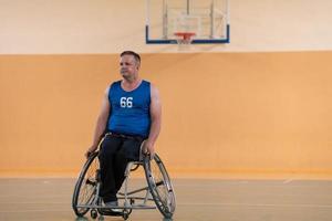 a photo of a war veteran playing basketball with a team in a modern sports arena. The concept of sport for people with disabilities