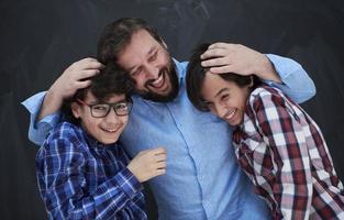 happy father hugging sons photo