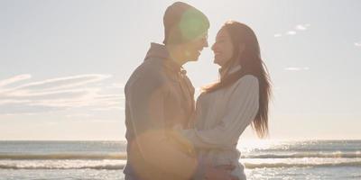 Couple having fun on beautiful autumn day at beach photo