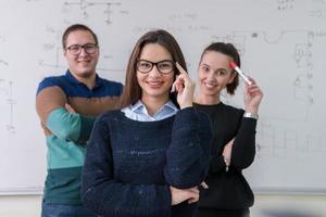 portrait of young students in front of chalkboard photo