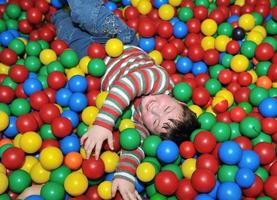 happy child in colorful balls photo