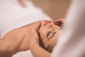 woman receiving a head massage photo