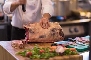 chef cutting big piece of beef photo