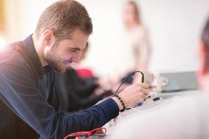 students doing practice in the electronic classroom photo