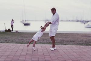 An elderly man in casual clothes with his daughter spends time together in the park on vacation. Family time. Selective focus photo