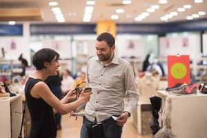 couple chooses shoes At Shoe Store photo