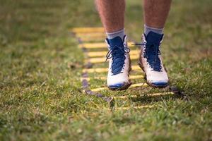 american football player exercises on ladder drills photo