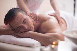 young man having a back massage photo