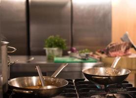 chef preparing food, frying in wok pan photo