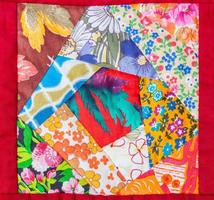 detail of patchwork quilt framed in red cloth photo