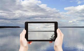 tourist taking photo of Lake Seliger, Russia